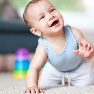cute-smiling-baby-boy-crawling-floor-living-room