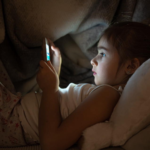 Little,Girl,Watching,Smartphone,In,Bed,,Kid,Using,Phone,And